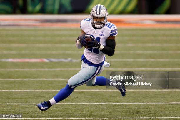 Ezekiel Elliott of the Dallas Cowboys runs with the ball in the second quarter against the Cincinnati Bengals at Paul Brown Stadium on December 13,...