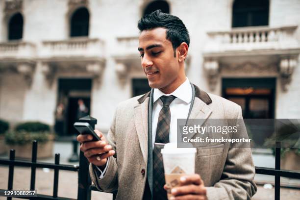 text messaging in wall street - wall street lower manhattan stock pictures, royalty-free photos & images