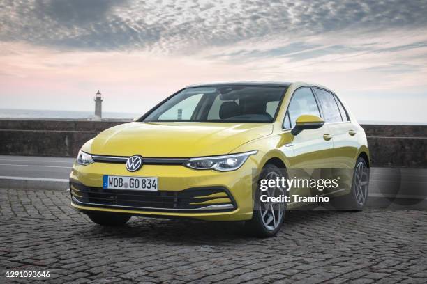 volkswagen golf on a parking - yellow car stock pictures, royalty-free photos & images