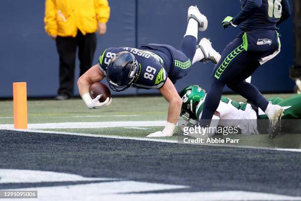 Will Dissly of the Seattle Seahawks dives in the end zone to score a 10 yard touchdown against the New York Jets in the game at Lumen Field on...