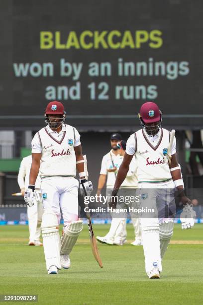 Shannon Gabriel and Jason Holder of West Indies leaves the field after being dismissed at the conclusion of day four of the second test match in the...