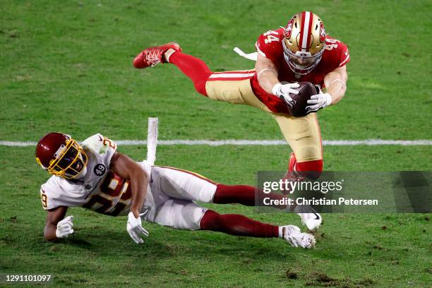 Fullback Kyle Juszczyk of the San Francisco 49ers dives into the end zone for a touchdown over cornerback Kendall Fuller of the Washington Football...