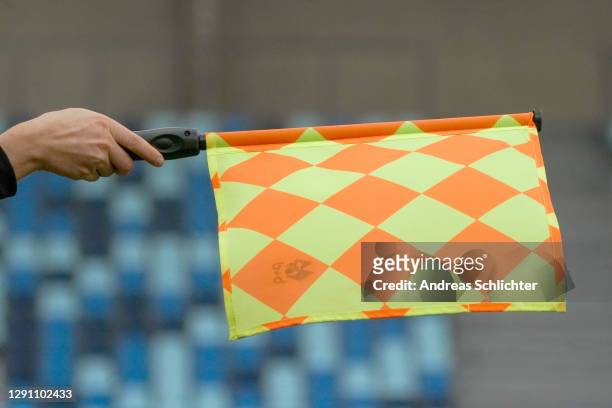 The referees assistant holds his flag out for offside during the 3. Liga match between 1. FC Saarbruecken and Bayern Muenchen II at...