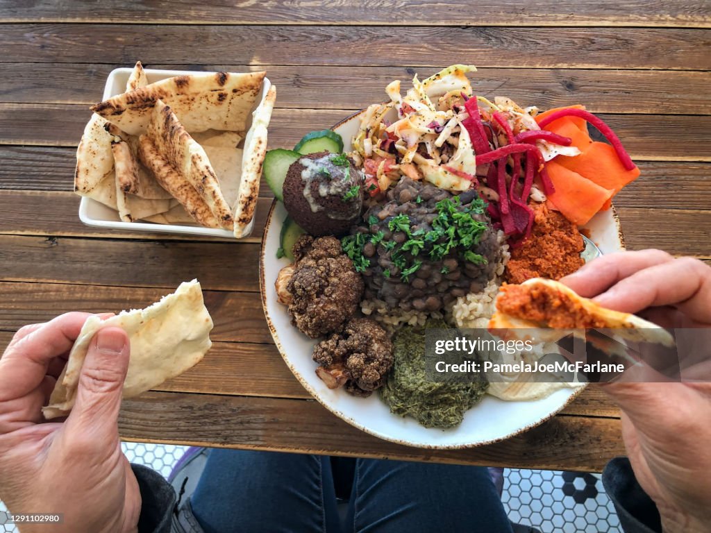 POV, Mature Woman Eating Vegan Traditional Lebanese Food in Cafe
