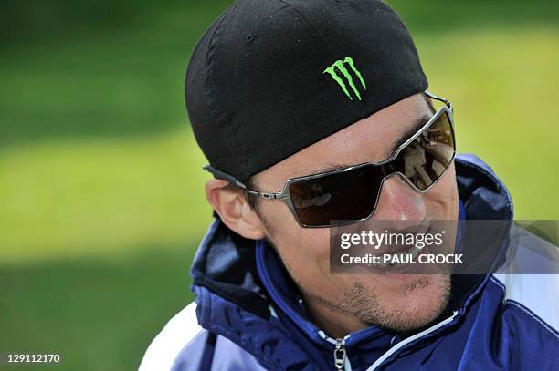 Yamaha rider Colin Edwards of the US relaxes at a trout farm during a media preview for the Australian Grand Prix motorcycling MotoGP race at Phillip...