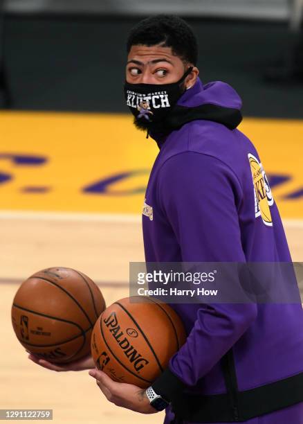 Anthony Davis wears a mask as he warms up before a preseason game against the LA Clippers at Staples Center on December 13, 2020 in Los Angeles,...