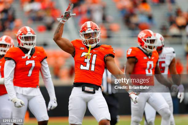 Safety Kolby Harvell-Peel of the Oklahoma State Cowboys celebrates after stopping the Texas Tech Red Raiders from converting on third down in the...