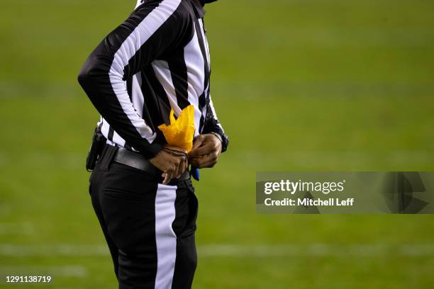 Referee puts his penalty flag back in his pocket during the game between the New Orleans Saints and Philadelphia Eagles at Lincoln Financial Field on...