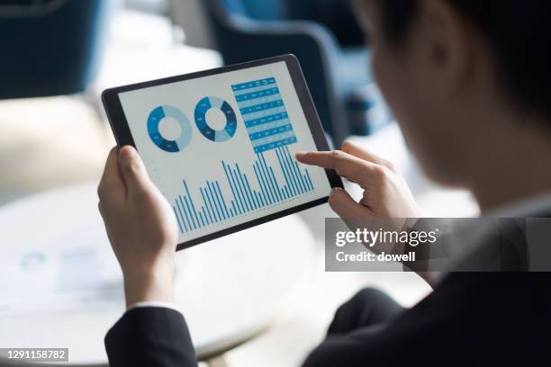 business report on digital tablet - business report stock pictures, royalty-free photos & images