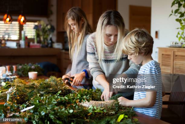 family making an advent wreath - münchen advent stock pictures, royalty-free photos & images