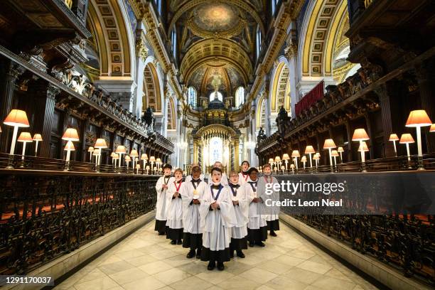 Choristers from the St Pauls Choir pose for photographers during a photo call at St Paul's Cathedral on December 14, 2020 in London, England. With...