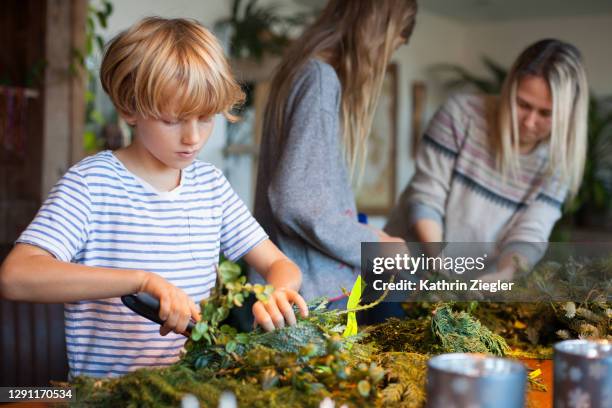 family making an advent wreath - advent wreath stock pictures, royalty-free photos & images