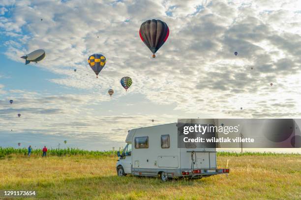 hot air balloon flying on sky balloon carnival chambley,france - bike flowers ストックフォトと画像