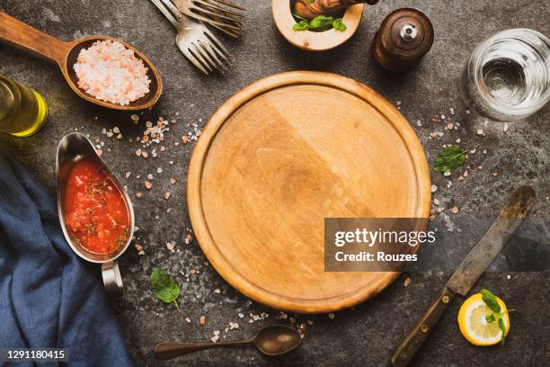 wooden pizza board and pizza cooking ingredients - table top imagens e fotografias de stock