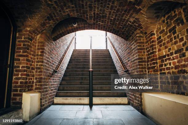 underground brick tunnel with staircase - subway bench bildbanksfoton och bilder