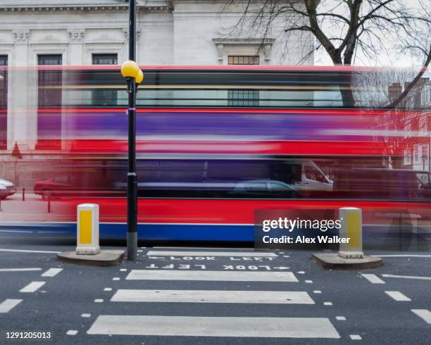 london bus blur across zebra crossing - underground london stock pictures, royalty-free photos & images