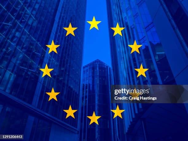 european union politics, business and finance concept piece with the eu flag overlaying skyscrapers and corporate buildings in the background. - eu trade stock pictures, royalty-free photos & images