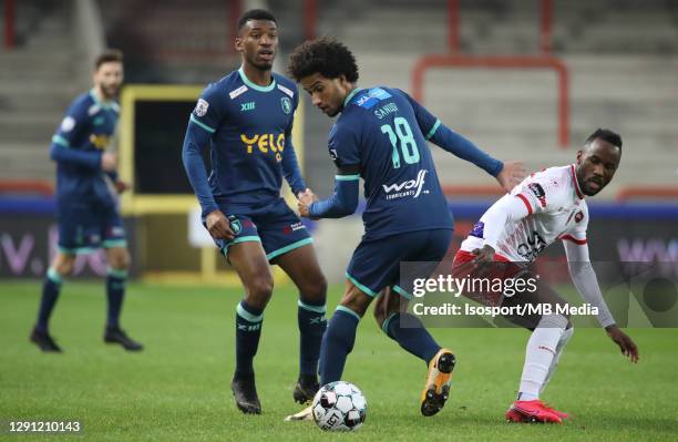 Ryan Sanusi of Beerschot battles for the ball with Fabrice Olinga of Mouscron during the Jupiler Pro League match between Royal Excel Mouscron and K....