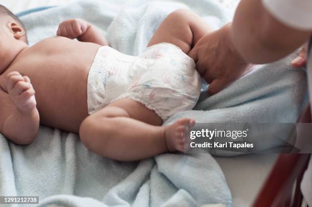 southeast asian baby boy changing diaper - changing diaper ストックフォトと画像