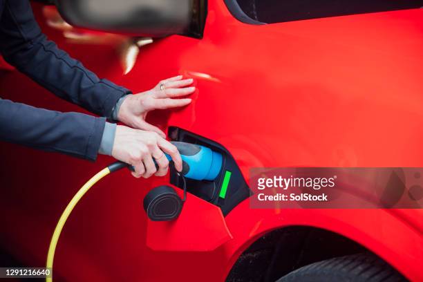 securing the charger - red car wire stock pictures, royalty-free photos & images