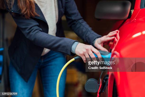 making sure its charged - electric car home stock pictures, royalty-free photos & images