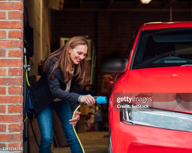 environment conscious car - electric vehicle charging station stock pictures, royalty-free photos & images