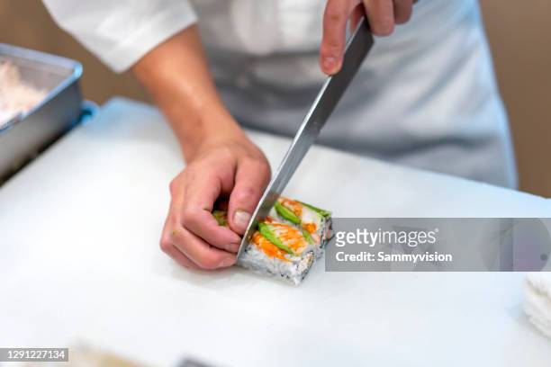 chef preparing maki sushi - chef knives stock pictures, royalty-free photos & images