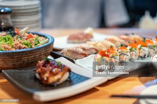close-up of variation of japanese food on table - sushi bar stock pictures, royalty-free photos & images