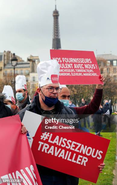 Demonstrator 'holds a banner reading 'Let us work', during a demonstration against government closure measures during the coronavirus disease out...