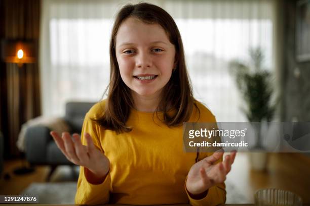 portrait of smiling young girl having video call at home - camera girls stock pictures, royalty-free photos & images