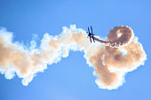 Aerobatic biplane on the blue sky
