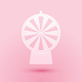 Paper cut Lucky wheel icon isolated on pink background. Paper art style. Vector