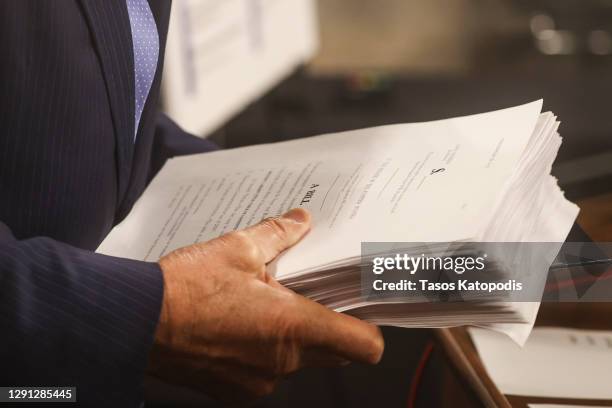 Sen. Joe Manchin carries the bill as he gets ready to speak alongside a bipartisan group of Democrat and Republican members of Congress as they...