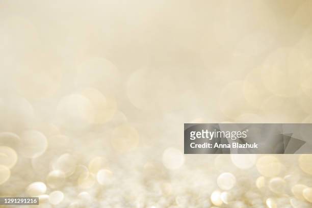 glittering golden and silver glowing shiny decoration background for holidays, new year and christmas - raggiante foto e immagini stock