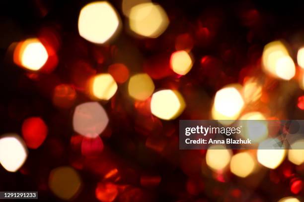 red and golden lights bokeh. glowing shiny romantic background for christmas, new year, valentine's day. - an evening with heart fotografías e imágenes de stock
