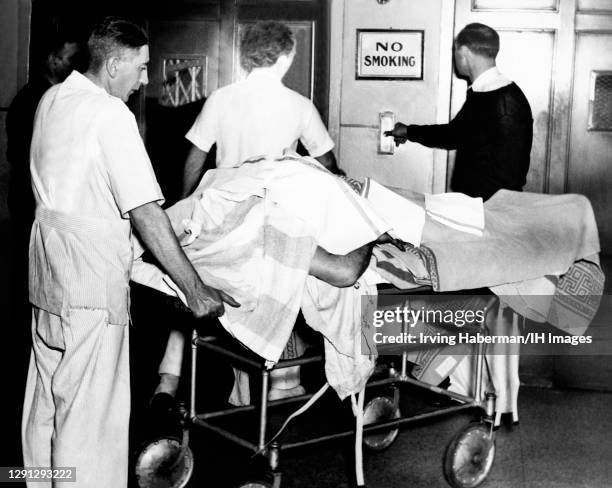 An unidentified dead body is transferred at the city morgue circa 1940 in Brooklyn, New York.