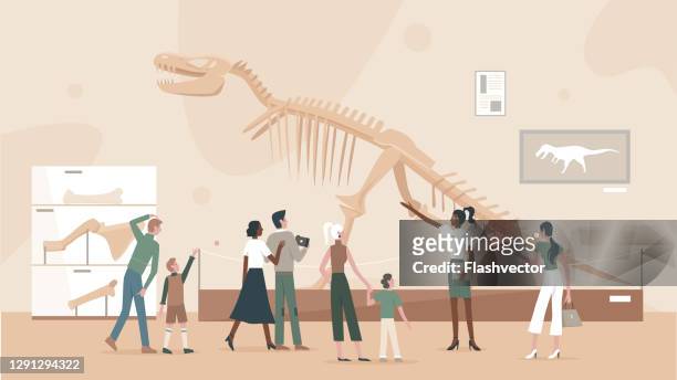 People in museum of paleontology near tyrannosaurus skeleton