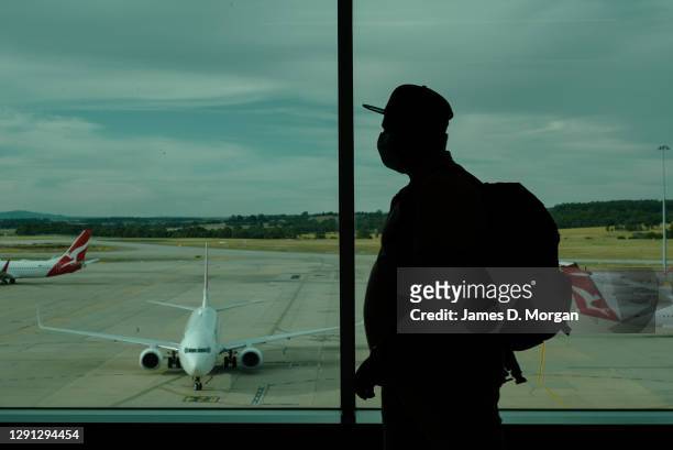 Passengers walk to Qantas planes at the domestic terminal at Melbourne Airport on December 13, 2020 in Melbourne, Australia. Domestic aviation has...
