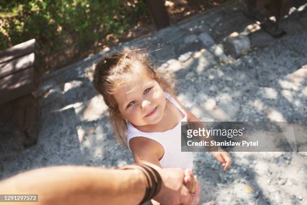 small girl holding father's hand on a walk - pov or personal perspective or immersion stock pictures, royalty-free photos & images