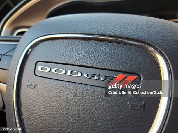 Close-up of a car steering wheel featuring the Dodge logo in Lafayette, California, December, 2020.