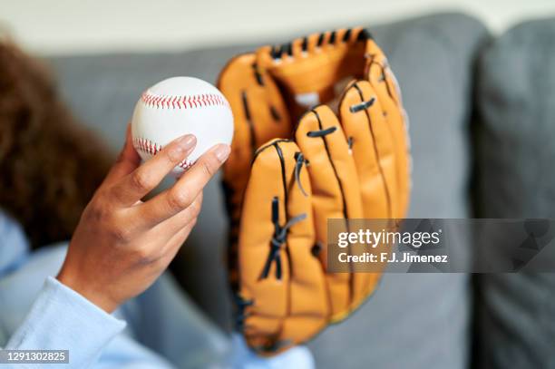 close-up of woman's hands with ball and baseball glove - baseball glove stock pictures, royalty-free photos & images