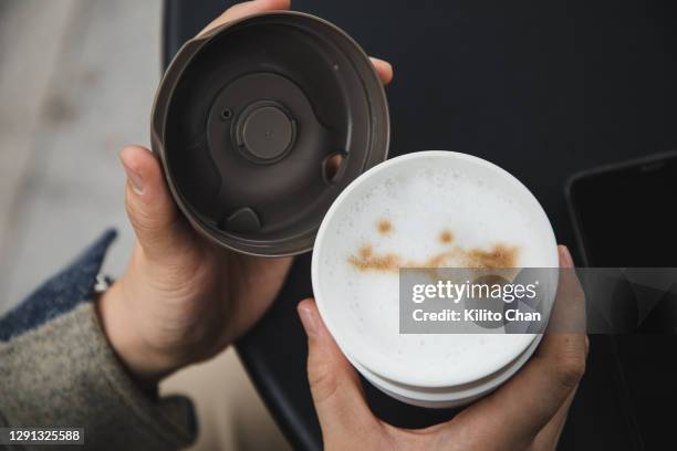 female hand holding a reusable coffee cup outdoor - lid stock pictures, royalty-free photos & images