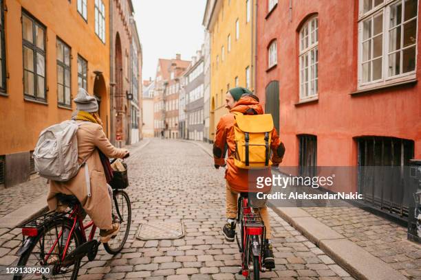 couple enjoying the city ride - copenhagen stock pictures, royalty-free photos & images