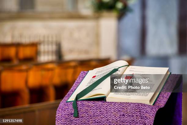 the holy book of the gospels displayed inside a catholic church on the aventine hill in the heart of rome - episcopal conference stock pictures, royalty-free photos & images