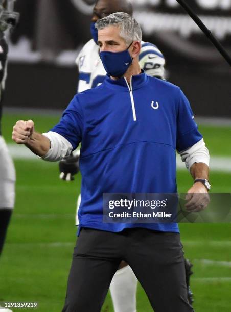 Head coach Frank Reich of the Indianapolis Colts walks across the field to greet head coach Jon Gruden of the Las Vegas Raiders after the Colts'...