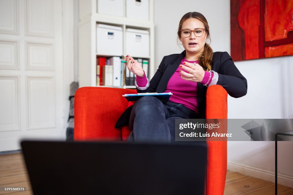 Psychologist providing psychological cognitive behavioral therapy over video call
