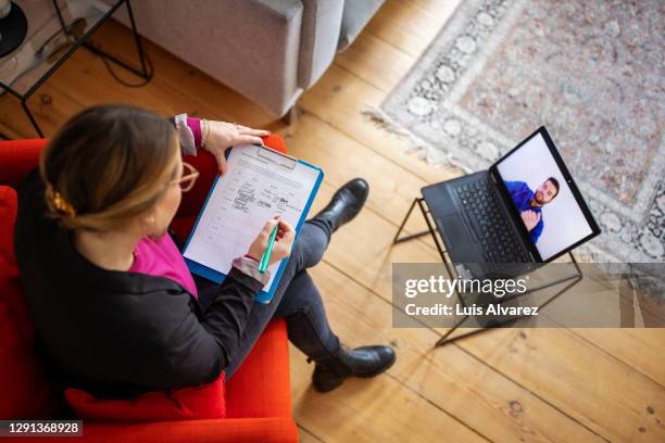 psychologist having online therapy session with a patient - patient information stock pictures, royalty-free photos & images