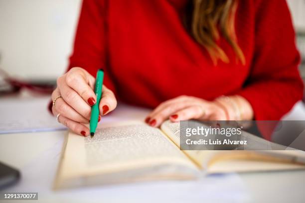 close-up of a woman reading a book - reference book stock pictures, royalty-free photos & images