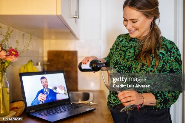 couple having wine during a video call - relation à distance photos et images de collection