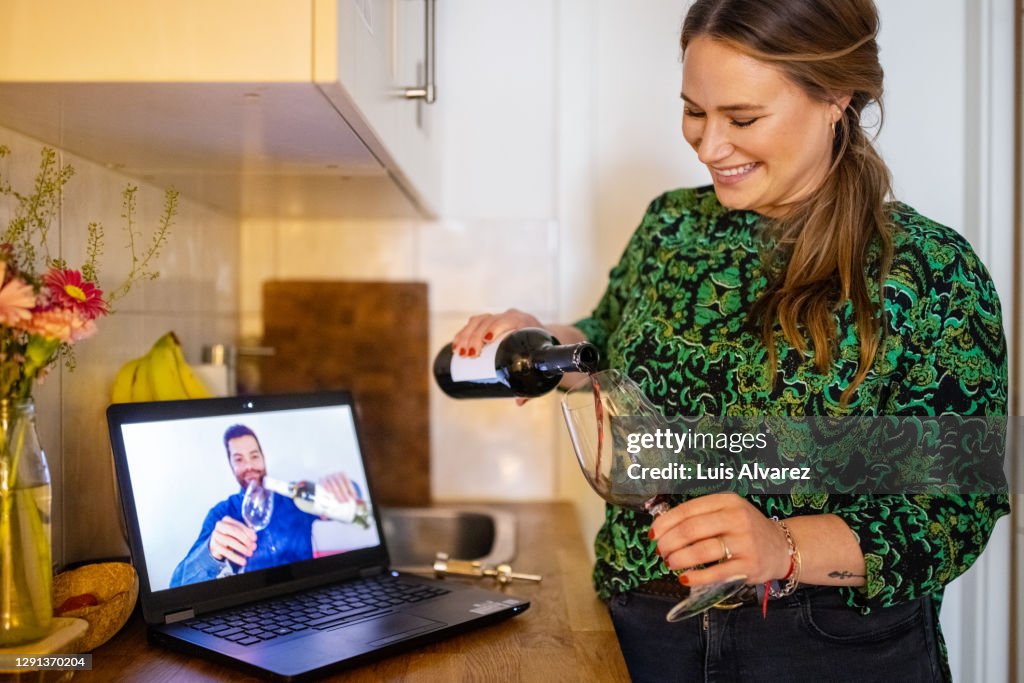 Couple having wine during a video call